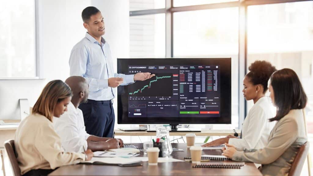 Business people, stock market dashboard on screen and coach for trading, finance presentation and g