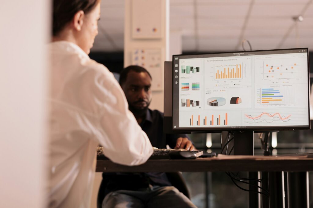 Employee analyzing company financial report dashboard on computer screen