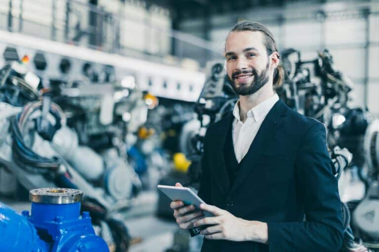Portrait jewish businessman standing happy in machine factory warehouse for success CEO